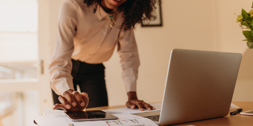 Woman working from home with a laptop and tablet